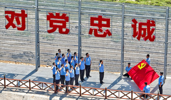 图二:参加主题党日活动民警在派出所“忠诚墙”下重温入党誓词。.jpg
